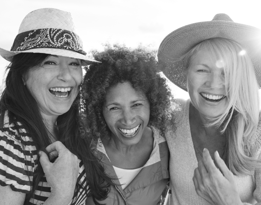 women with hats laughing at camera for some reason